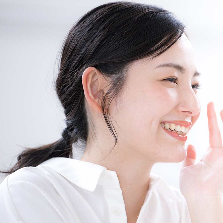 Young woman in a white shirt smiling