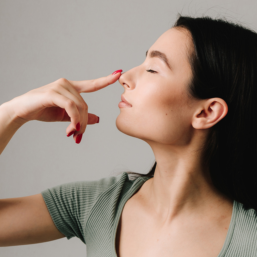 Woman touching her nose